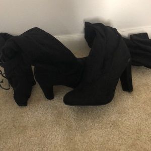 Thigh high black heeled boots. Never worn.